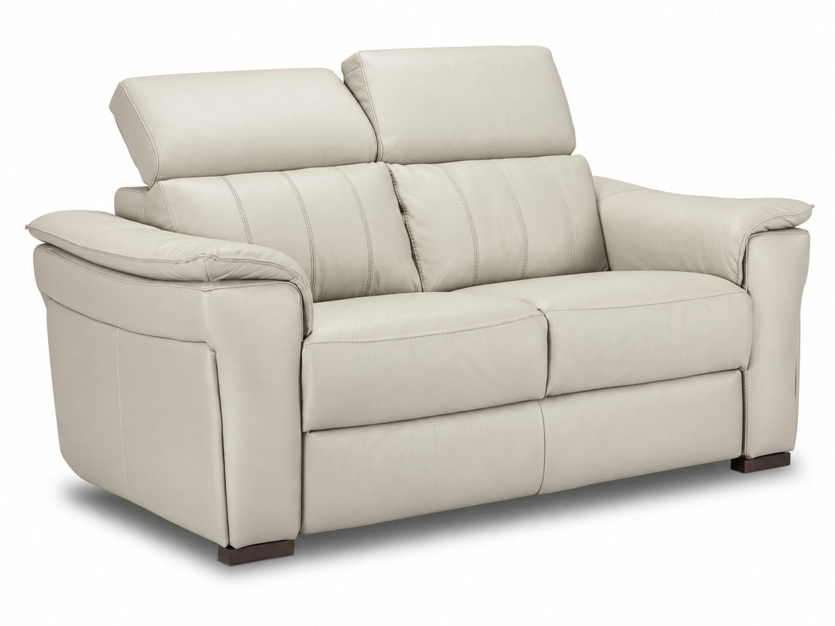 Angled cream leather loveseat with one adjustable headrest lowered