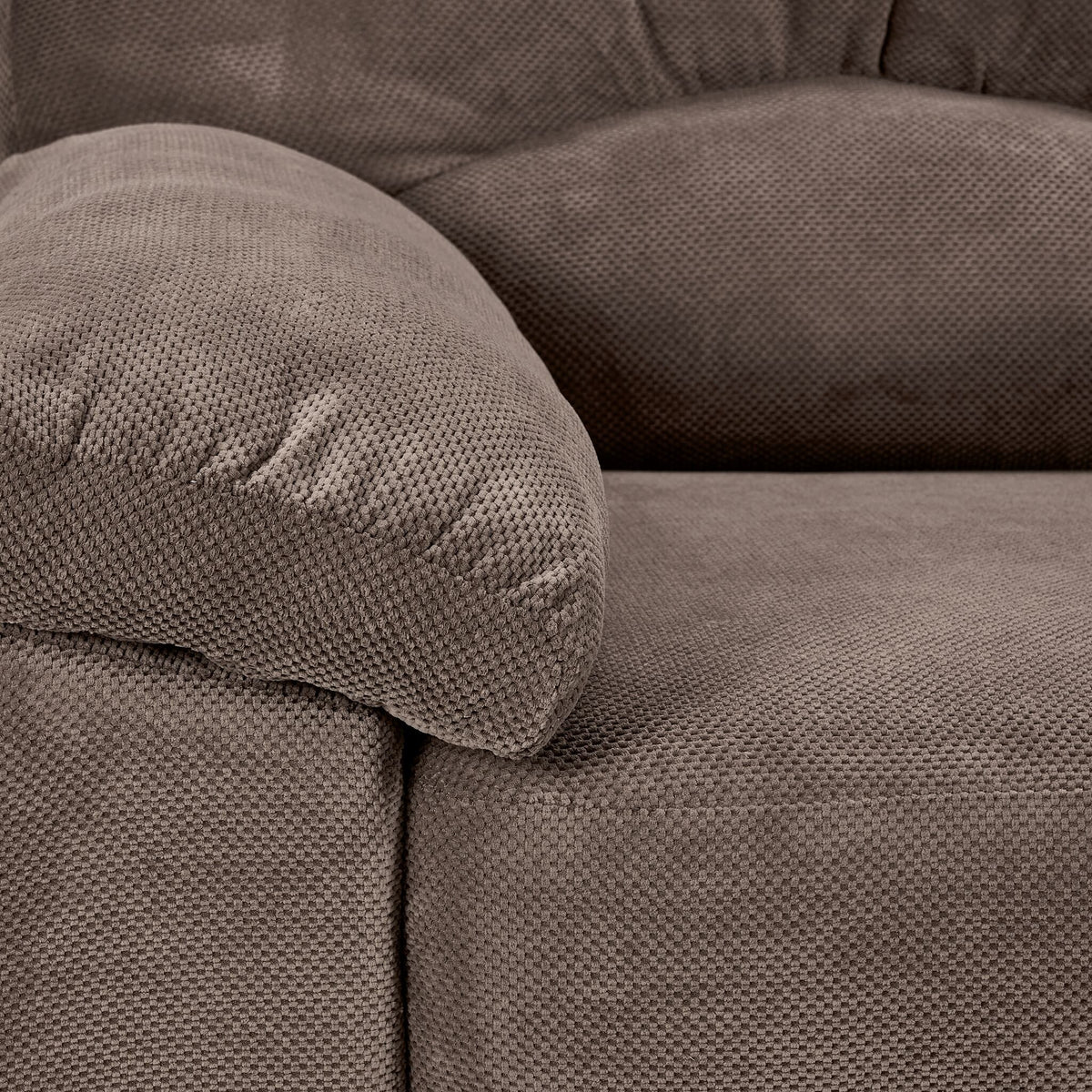Close-up of Archie ash polyester upholstery showing its textured weave and plush padded arm.