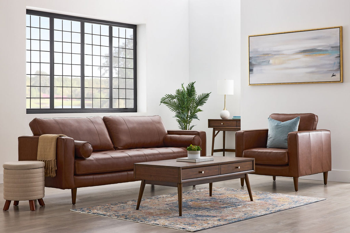 Bari Leather Sofa and Chair in cobblestone brown styled in a bright living room with a wood coffee table, area rug and large window