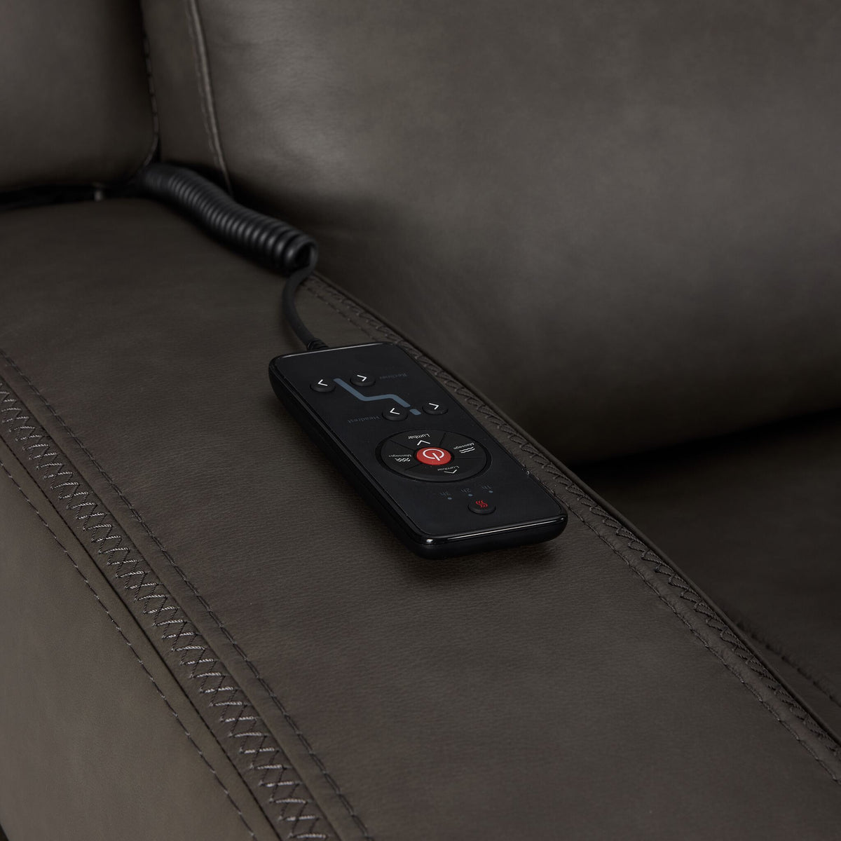 Jackson anthracite leather loveseat close-up showing wired remote for power recline, heat and massage controls