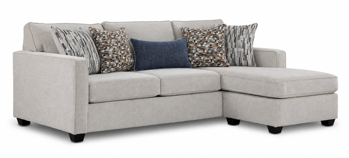 Laila reversible sofa chaise in beige polyester with transitional styling, patterned pillows and right-side chaise