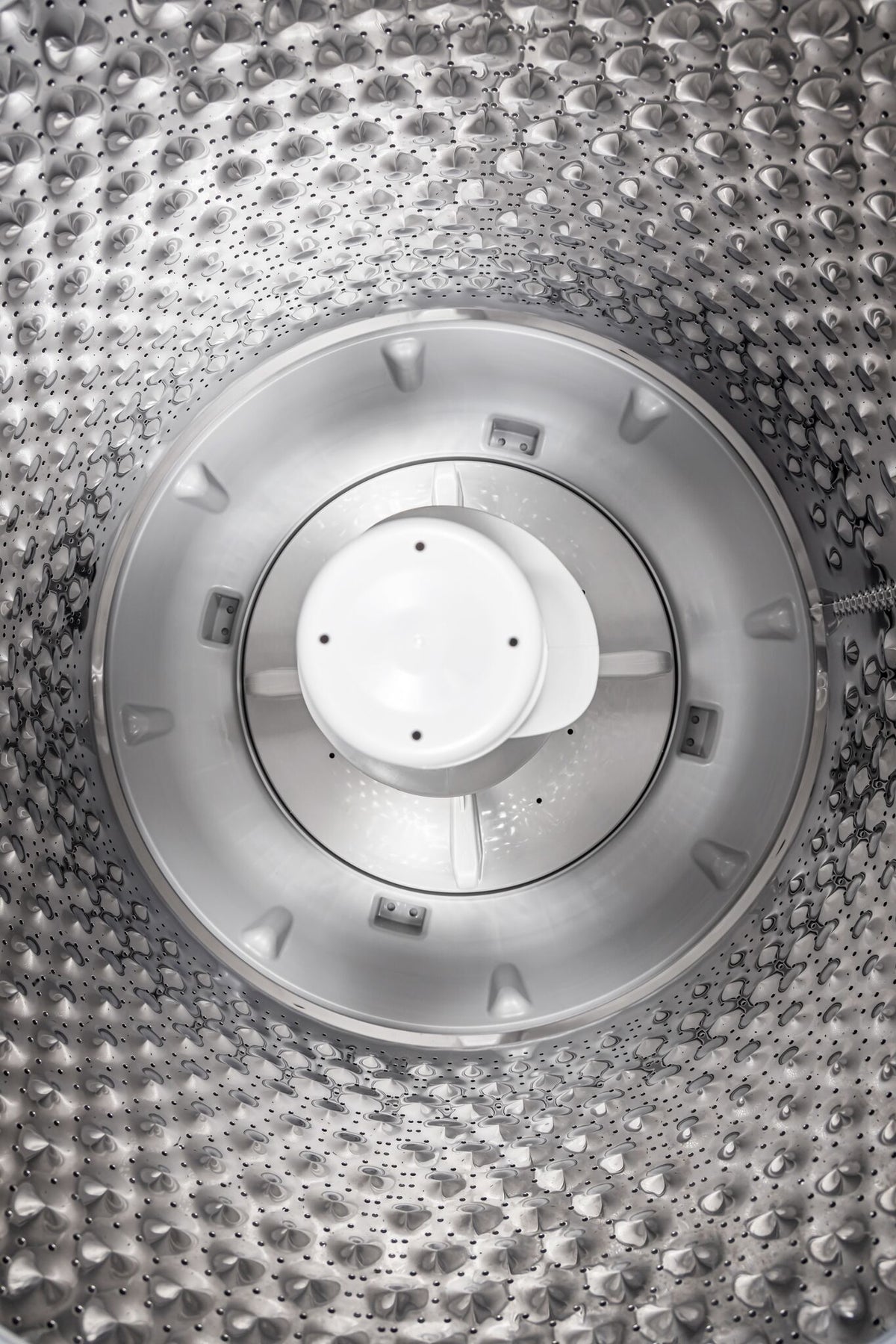Top view of the stainless steel wash tub with white central agitator