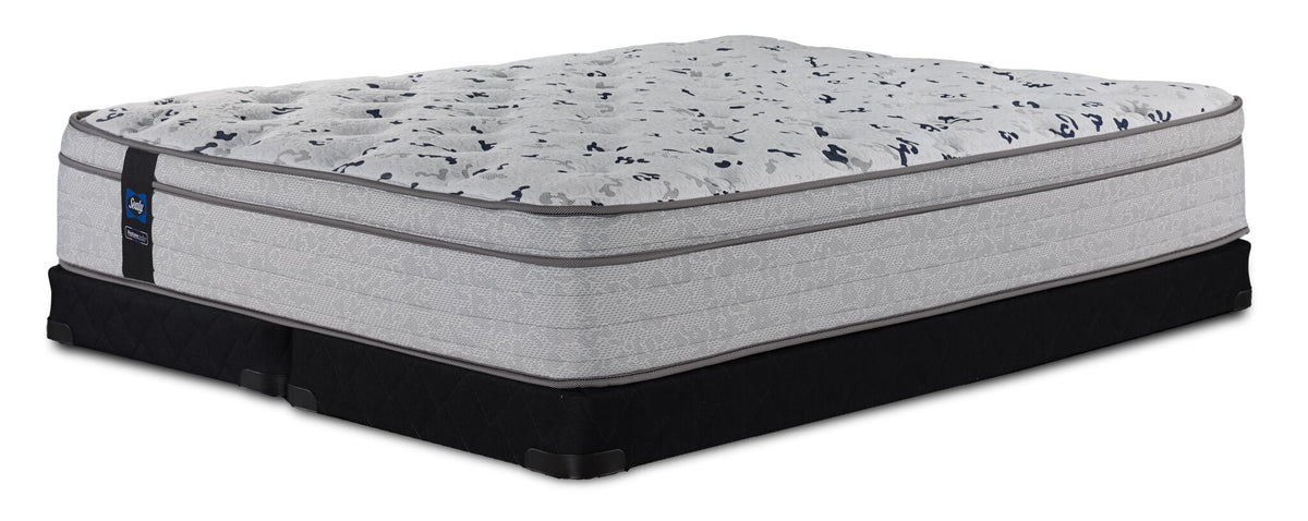 Sealy Comfort Series 2 King medium mattress on two black low-profile split boxsprings