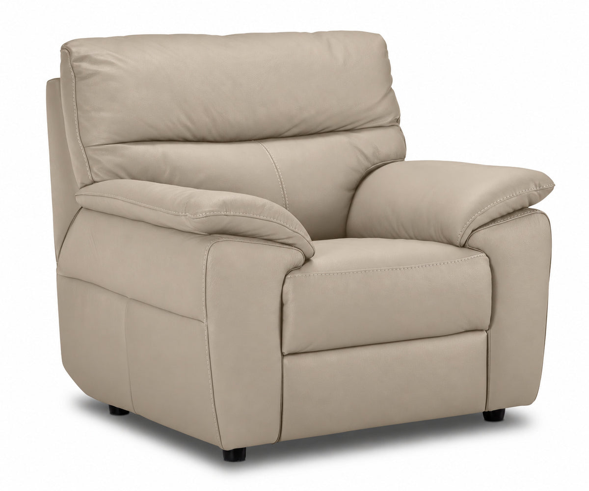 Matching tan leather chair with deep seat, cushioned back and wide padded arms