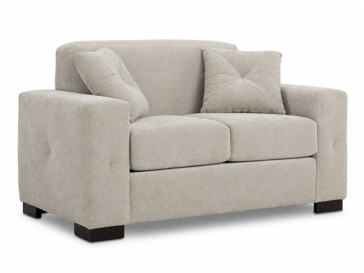 Valetta Loveseat - Ivory angled view with two seat cushions, wide track arms, dark block feet and two matching accent pillows