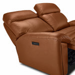 Apollo mocha leather loveseat close-up showing adjustable headrests, padded arm and side-mounted power controls
