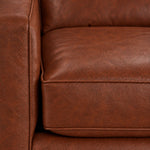 Close-up of the City Leather collection in Brown showing textured leather upholstery, piped cushion edges and stitching