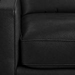 Close-up of the City Leather Loveseat - Black showing the leather grain, piped seat cushion and matching upholstered arm
