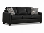 City Leather Sofa - Black in a three-quarter view with three seat cushions, slim track arms, dark wood legs and two patterned accent pillows