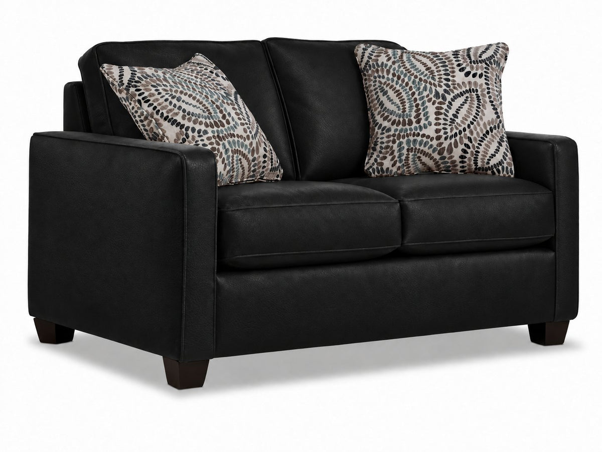 City Leather Loveseat - Black in a three-quarter view with two cushioned seats, patterned accent pillows and dark wood legs