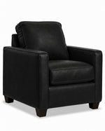 City Leather Chair - Black in a three-quarter view with a cushioned seat and back, slim track arms and dark wood legs