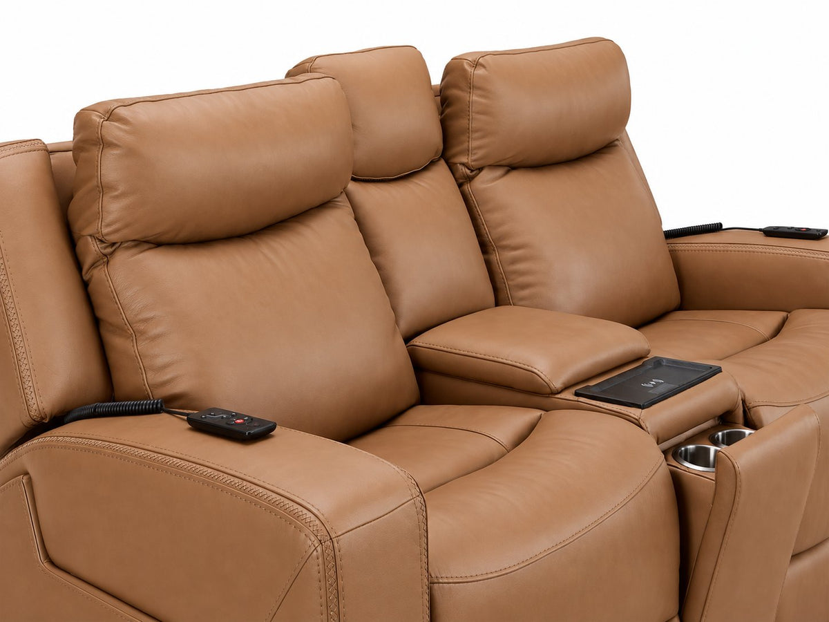 Jackson butternut leather loveseat close-up showing padded headrests, stitched seats, remotes and centre console