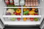 Two clear produce drawers filled with assorted fruits and vegetables
