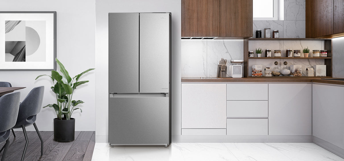 Stainless steel Midea French door refrigerator installed in a modern white kitchen