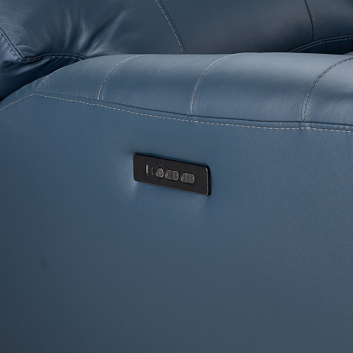 Apollo navy leather sofa close-up showing side-mounted power recline controls and USB charging ports