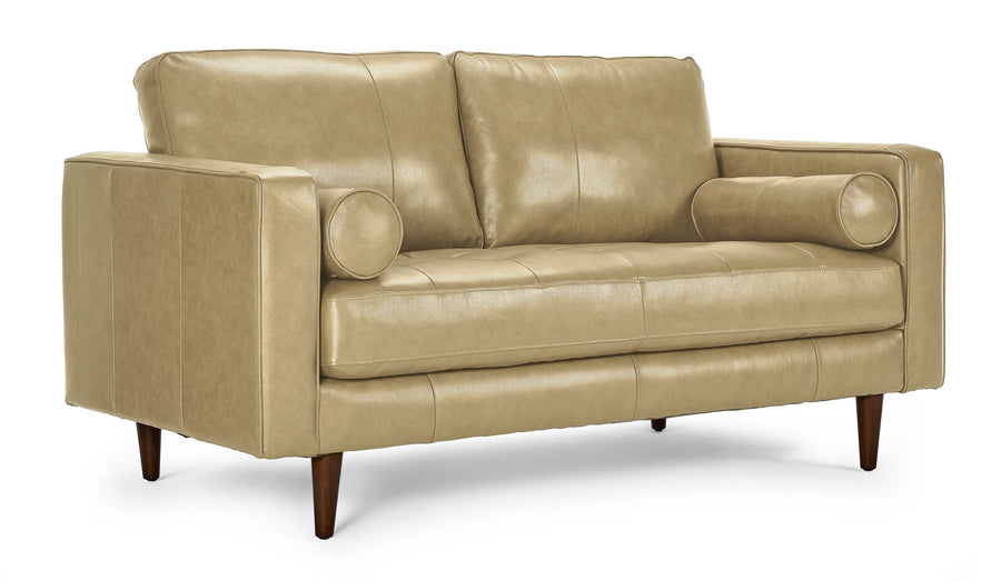 Bari Leather Loveseat in stone, shown at an angle with two back cushions, tufted bench seat, cylindrical bolster pillows and tapered wood legs