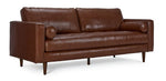 Bari Leather Sofa in cobblestone brown, shown at an angle with tufted seat, two bolster pillows, track arms and tapered wood legs
