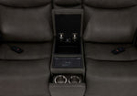 Jackson anthracite loveseat close-up showing open centre storage, wireless charging pad, cupholders and two remotes