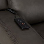 Jackson anthracite leather sofa close-up showing wired remote for power recline, heat and massage controls