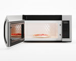 Open microwave with illuminated interior and pizza on the glass turntable