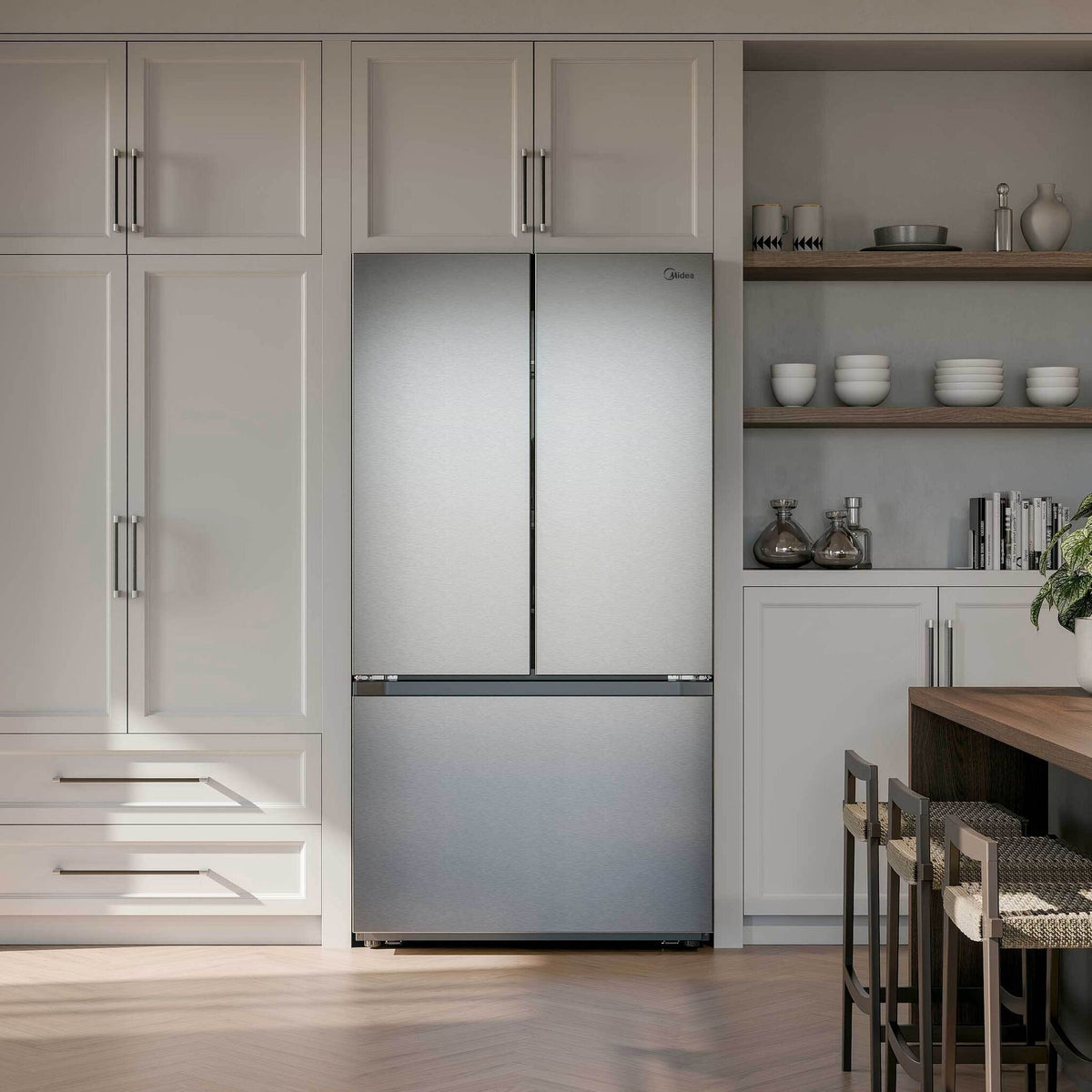 Stainless steel French door refrigerator installed within light kitchen cabinetry