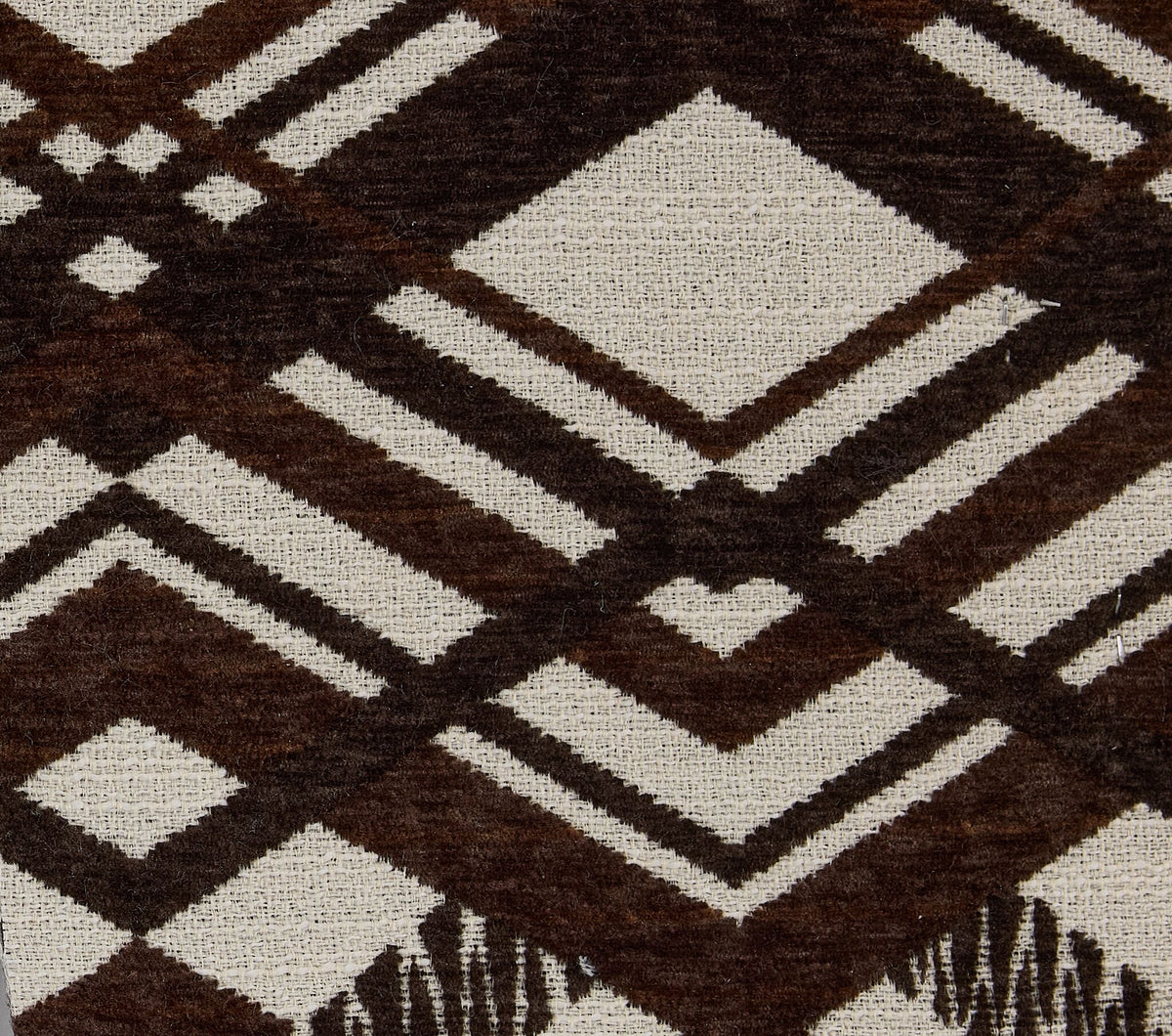 Close-up of Nichols Sofa accent pillow fabric with brown and cream geometric pattern