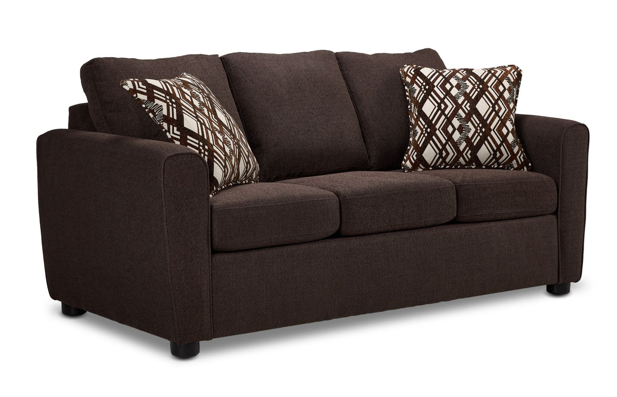 Nichols Sofa - Chocolate in angled view with three seat cushions, rounded arms and two patterned accent pillows