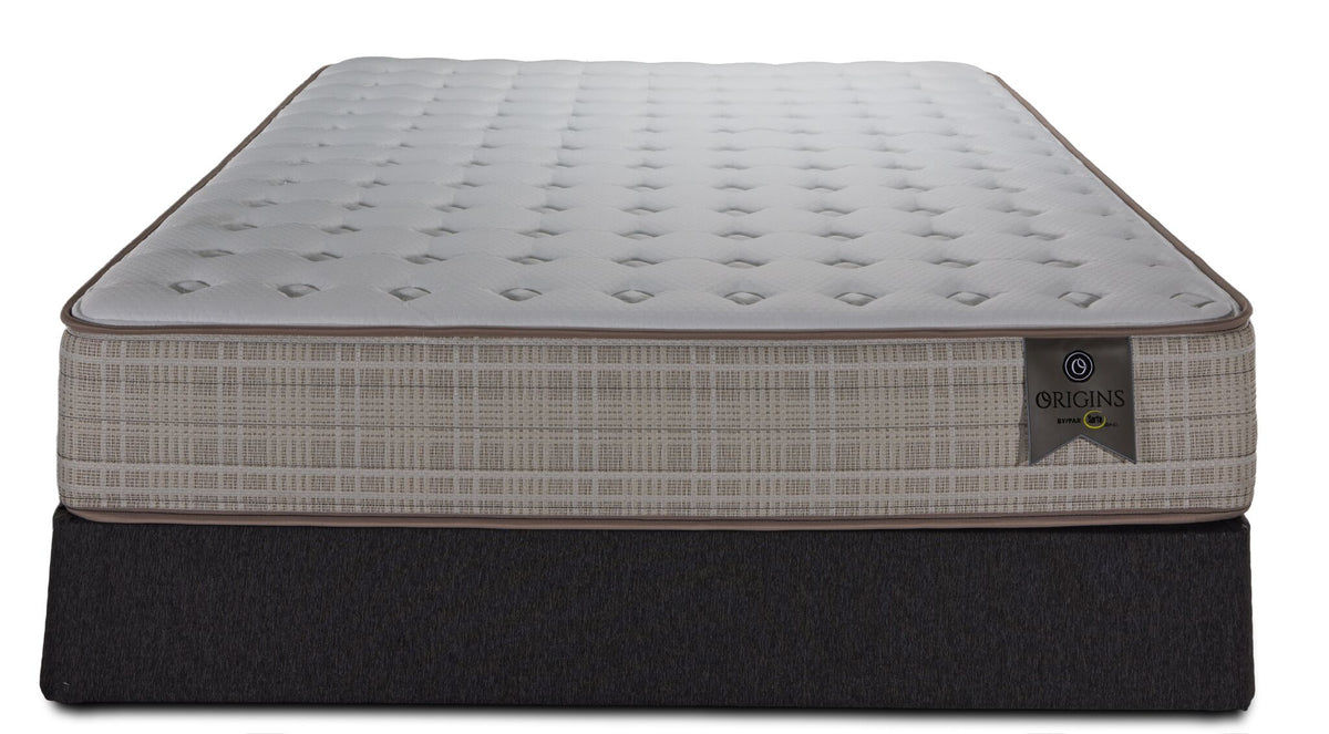 Front view of the Twin XL mattress and boxspring with beige patterned sides and Origins label