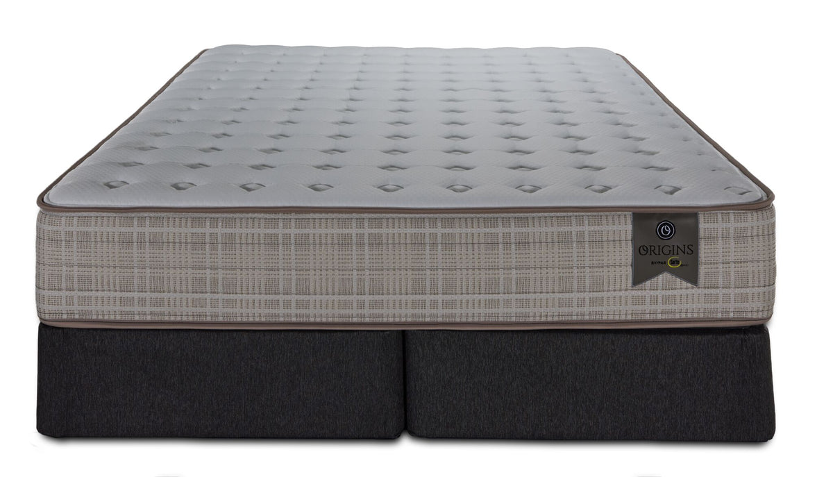 Front view of the Queen mattress with two split boxsprings, beige patterned sides and Origins label