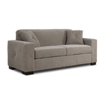 Valetta Sofa - Wheat angled view with wide track arms, two seat cushions, dark block feet and two accent pillows