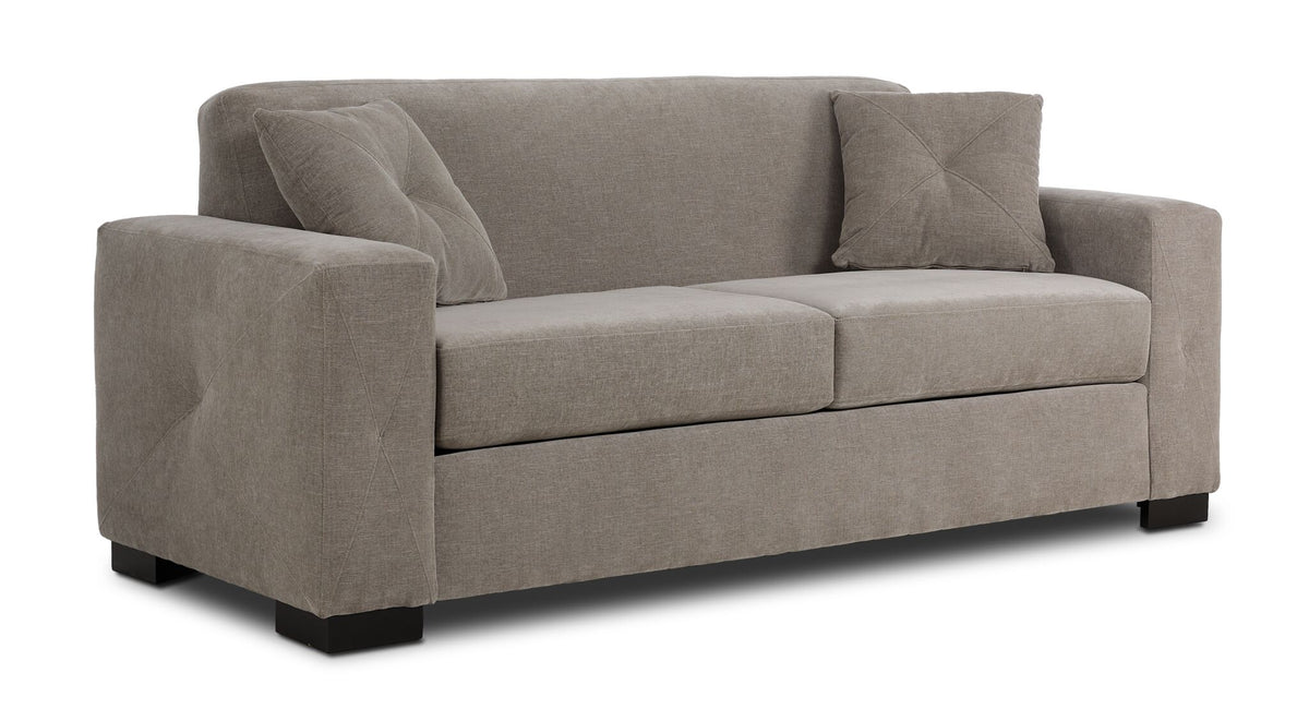 Valetta Sofa - Wheat angled view with wide track arms, two seat cushions, dark block feet and two accent pillows