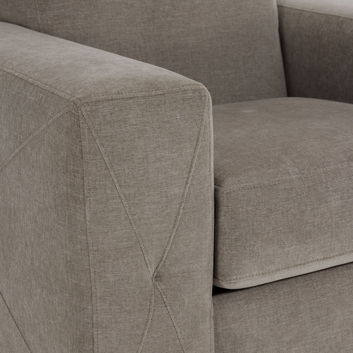 Valetta Chair - Wheat close-up showing textured upholstery and decorative cross stitching on the wide track arm