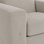 Valetta Loveseat - Ivory close-up showing textured upholstery and decorative cross stitching on the wide track arm