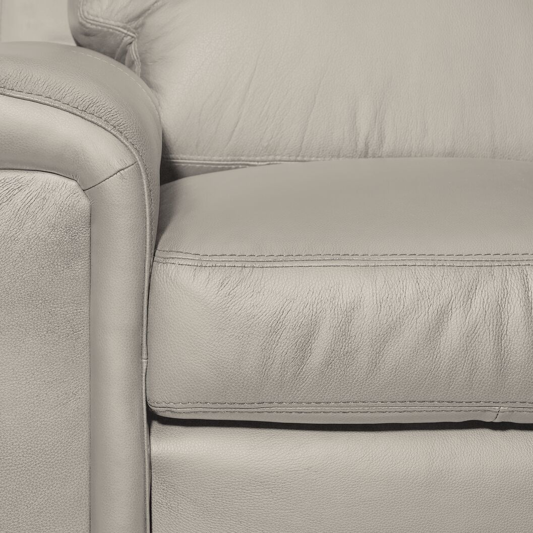 Icon Leather Sofa - Silver Grey close-up showing genuine leather upholstery, stitching, arm and seat cushion